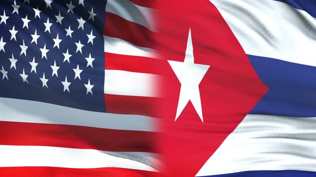 USA and Cuba officials exchanging confidential envelope, flags background