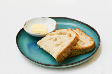 Bread and butter on blue plate