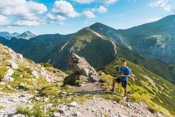 Fototapeta premium sporty man hiker on top of mountain, Tatry