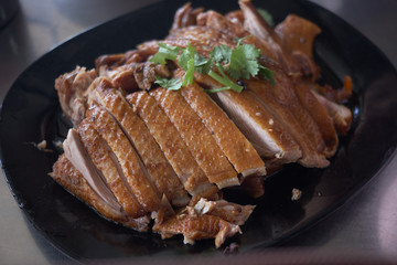 steamed duck meat in Chinese brown soup on plate