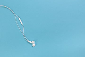 white headphones on blue background