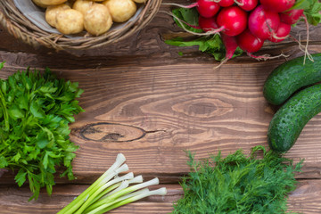Frame on wooden background from fresh organic vegetables. A set of different vegetables.