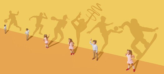 Childhood and dream concept. Conceptual image with children and shadow on the yellow studio wall....