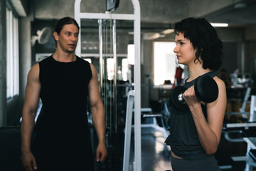Fototapeta na wymiar Fitness woman with personal trainer at gym.