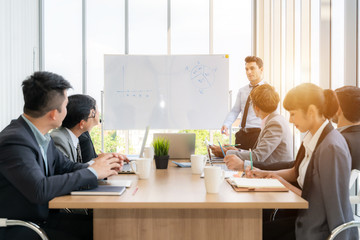 Businesspeople discussing together in conference room during meeting at office.