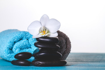 Orchid on stones and towel