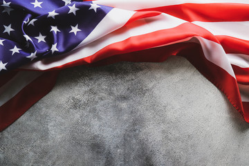 Patriotic composition w/ ruffled American flag on concrete background. United States of America...