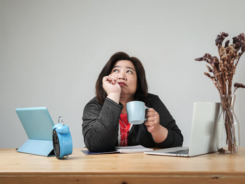 Asian Fat Woman Drinking Coffee And Thinking Something At Home, Lifestyle Concept.