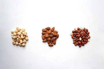 Hazelnuts, almonds and peanuts isolated on white background from a high angle view
