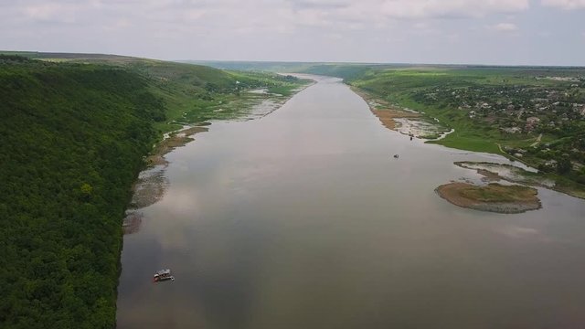 Flying over the river on a sunny summer day. Dniester river of Moldova republic.