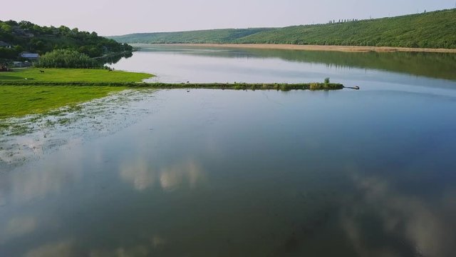 Flying over the river on a sunny summer day. Dniester river of Moldova republic.