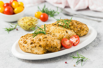 Baked mustard honey chicken breasts with cherry tomatoes. Selective focus, space for text.