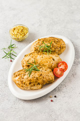 Baked mustard honey chicken breasts with cherry tomatoes. Top view, space for text.