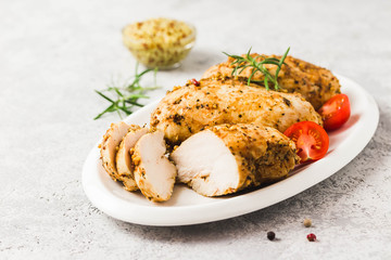 Baked mustard honey chicken breasts with cherry tomatoes. Selective focus, space for text.