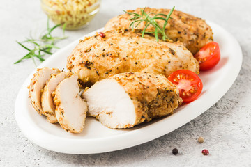 Baked mustard honey chicken breasts with cherry tomatoes. Selective focus, space for text.