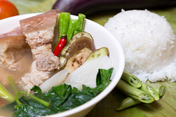 Philippine traditional dish: Sinagang pork soup with vegetables and rice