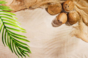 Summer background with copy space. Top view of sandy beach with visible sand texture and exotic accessories. Backdrop for products and mockup.