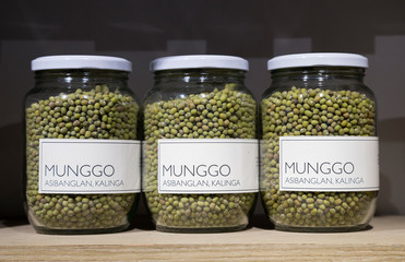 Glass jars with green mung beans (munggo) on dispaly in a store