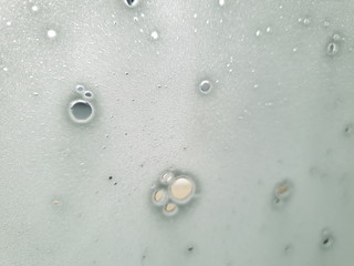 Foam layer on the front screen of the car during car wash