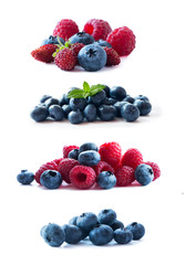 Pink and blue berries. Ripe blueberries, wild strawberries, raspberries, currants, mulberries and strawberries. Background of mix berries with copy space for text. Mix berries on white background.