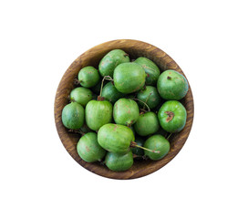 Green baby kiwi fruit actinidia isolated on white background. Actinidia in a bowl with copy space for text. Kiwi fruit actinidia close-up. Background berry. Sweet and juicy berry. Top view.
