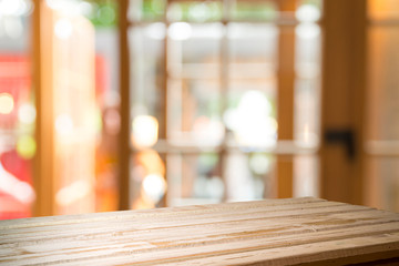 Empty of wood table top on blur of curtain with window view green from tree garden background.For montage product display or design key visual layout