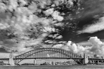 Beautiful black and white view of the Sydney Harbour Bridge, Australia, against a dramatic sky