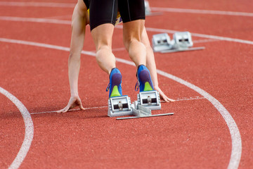 Runners preparing for race at starting blocks