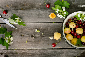 Naklejka na ściany i meble Fruits over wood rustic background - cherry and apricot, Food still Life