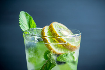 Fresh summer cocktail with blueberry and kiwi on the wooden background. Selective focus. Shallow depth of field. 