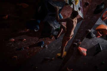 Athletic man practicing in a bouldering gym © Nejron Photo