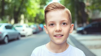 Fotobehang Kapsalon Portrait of happy boy with cool hipster haircut - Charming young casual smiling kid with trendy hairstyle - man fashion concept  © DanRentea