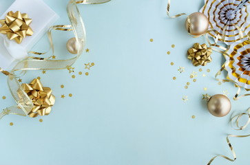 christmas or new year frame decorations in gold colors on pastel blue color background with empty copy space for text. holiday and celebration concept for postcard or invitation. top view 