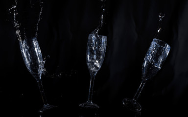 Black background with water glasses floating