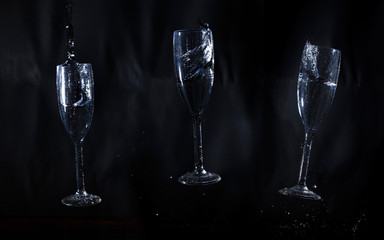 Three glasses of water on black background