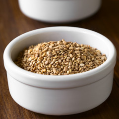 Roasted sesame seeds in small bowl, photographed with natural light (Selective Focus, Focus one third into the seeds)