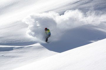 Snowboarder in fine white powder snow