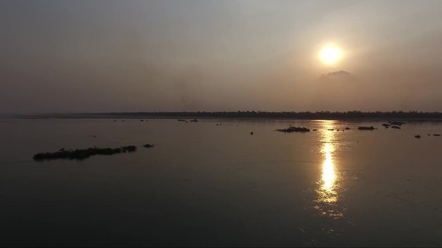 View of a Sap lake in Cambodia during the sunset. Lake view with a reflection of golden light on the water.