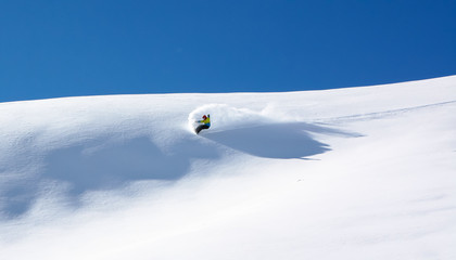 Snowboarder in fine white powder snow