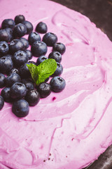 Fresh blueberry cheesecake on the rustic background. Selective focus. Shallow depth of field.