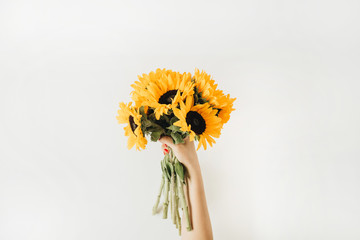 Sunflowers bouquet in female hands. Flat lay, top view summer floral hero header. © Floral Deco