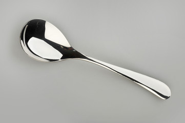 Spoon on a gray background used in restaurants