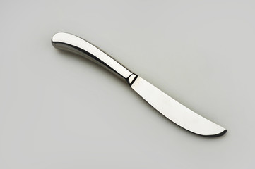 Knife on a gray background used in restaurants