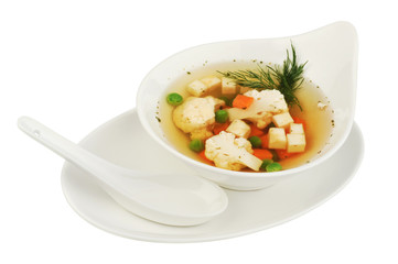 Vegetable soup with cauliflower, potatoes, peas, carrots and dill on a white isolated background