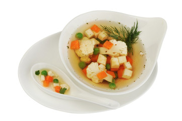 Vegetable soup with cauliflower, potatoes, peas, carrots and dill on a white isolated background
