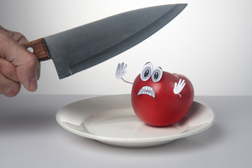 Scared tomato, sad tomato. Vegetarian concept. Vegetable abuse.
