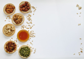 Many different nuts poured into tartlets with honey