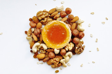 Many different nuts poured into tartlets with honey