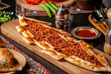 Traditional Turkish cuisine. Turkish pizza Pita with meat. Turk Pidesi or  Sucuk Pide. Beautiful...