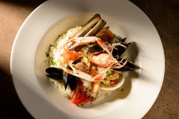 Rice with seafood on a plate in restauant ready to be served